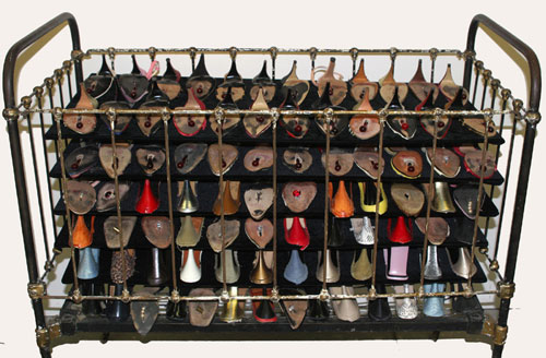 Paid, 2010 — Used women's shoes, antique iron crib, slumped glass, steel — Shirley Klinghoffer