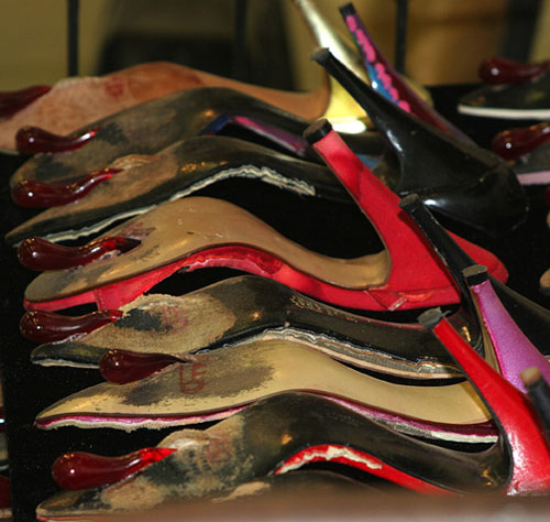 Paid (side view detail), 2010 — Used women's shoes, antique iron crib, slumped glass, steel — Shirley Klinghoffer
